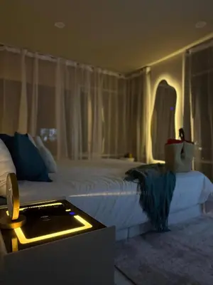 a bedroom with a large white bed with a light on it at Jungle House Phuket - Seaview Retreat in Patong Beach