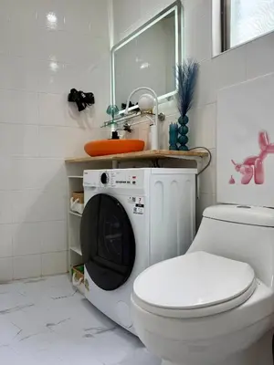 a bathroom with a toilet and a washing machine at Jungle House Phuket - Seaview Retreat in Patong Beach