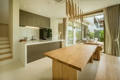 a kitchen and dining room with a wooden table at Akal pool villa 3BR near Laguna, Bangtao & Beach in Bang Tao Beach