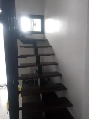 a staircase in a room with a light on it at Utopia Naiharn Loft Condo in Rawai Beach