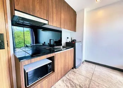 a kitchen with a sink and a microwave at Utopia Naiharn Loft Condo in Rawai Beach