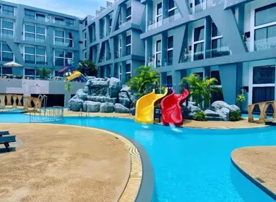 a resort with a water slide in a swimming pool at Utopia Naiharn Loft Condo in Rawai Beach