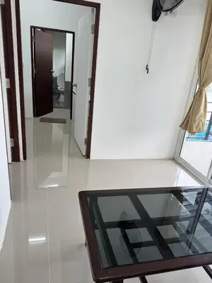 a room with a glass table and a mirror at Riverside Hostel Phuket in Phuket Town