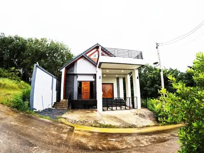 a small house sitting on the side of a road at Krabi Top Sea Hill Villa in Klong Muang Beach
