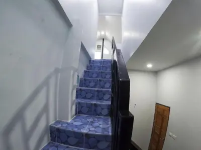 a staircase with blue tiles in a room at Krabi Top Sea Hill Villa in Klong Muang Beach