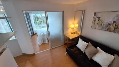 a living room with a couch and a sliding glass door at Plus 2 condo by Tida 111 in Kathu