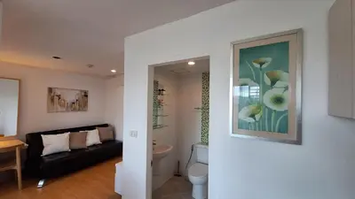 a living room with a couch and a bathroom at Plus 2 condo by Tida 111 in Kathu