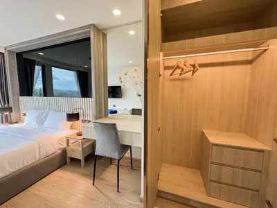 a bedroom with a bed and a desk at Luxury Ozone Bang Tao 1 Bdr in Laguna Phuket