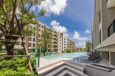 an empty swimming pool in an apartment building at Space 404 - 1BDR with Coworking, Pool & Gym Access in Bang Tao Beach