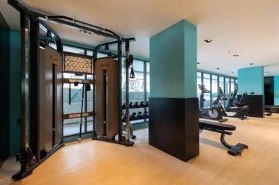a gym with treadmills and elliptical machines at Space 404 - 1BDR with Coworking, Pool & Gym Access in Bang Tao Beach
