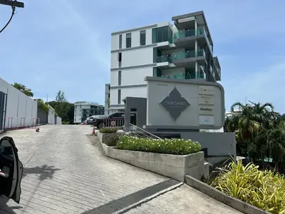 a building with a sign in front of it at Spectacular two bed penthouse amazing sea views in Patong Beach