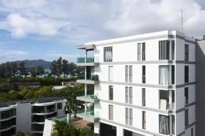 an external view of a white building at Spectacular two bed penthouse amazing sea views in Patong Beach