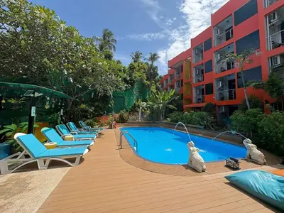 a row of lounge chairs next to a swimming pool at THE PORTERHOUSE Boutique Hotel in Patong Beach