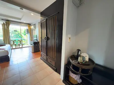 a room with a bed and a door with a phone at THE PORTERHOUSE Boutique Hotel in Patong Beach