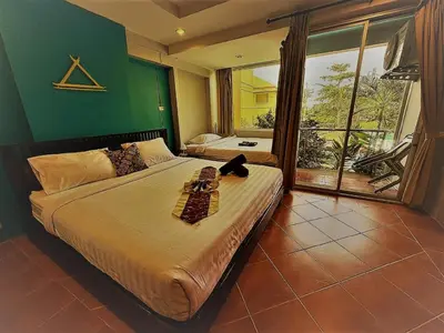 a bedroom with a bed with a cat sitting on it at THE PORTERHOUSE Boutique Hotel in Patong Beach