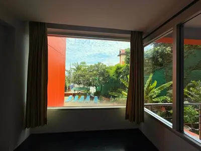 a window in a room with a view of a garden at THE PORTERHOUSE Boutique Hotel in Patong Beach