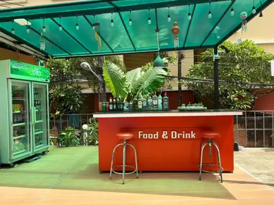 a food and drink counter with stools in front of a store at THE PORTERHOUSE Boutique Hotel in Patong Beach