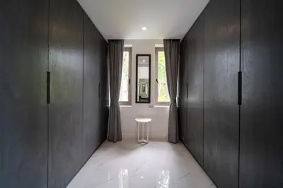 a hallway with wooden cabinets and a stool in a room at Seascape 6BR Prestige Villa Skyline Pool in Kamala Beach