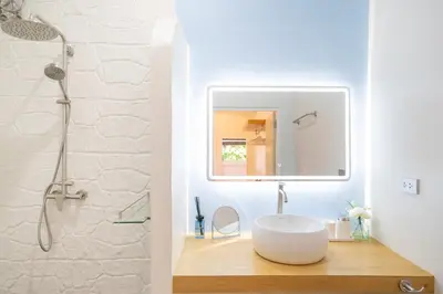 a bathroom with a sink and a mirror at Stylish Studio with Pool - 8' walk to Rawai Beach - 