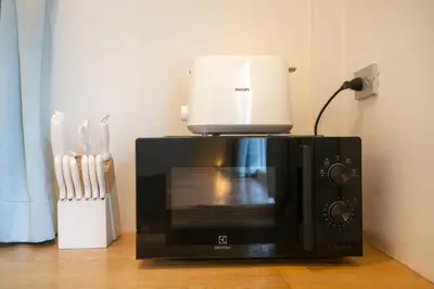 a microwave with a rice cooker on top of it at Stylish Studio with Pool - 8' walk to Rawai Beach - 