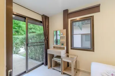 a bathroom with a mirror and a sink and a window at V247 Poolside 1BR Near Naiharn Beach & Gym in Rawai Beach