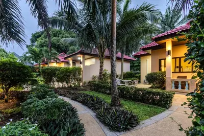 a house with palm trees in front of it at V247 Poolside 1BR Near Naiharn Beach & Gym in Rawai Beach