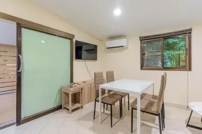 a dining room with a white table and chairs at V247 Poolside 1BR Near Naiharn Beach & Gym in Rawai Beach