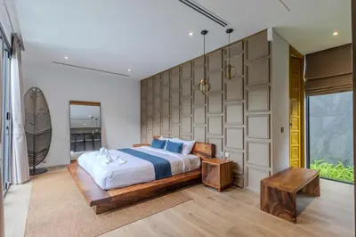 a bedroom with a large bed and a wall at V253 Brand New 2BR with Pool and Full Kitchen in Thalang