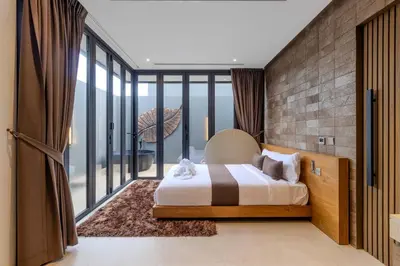 a bedroom with a bed and a large window at V253 Brand New 2BR with Pool and Full Kitchen in Thalang