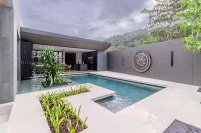 a swimming pool in the backyard of a house at V253 Brand New 2BR with Pool and Full Kitchen in Thalang