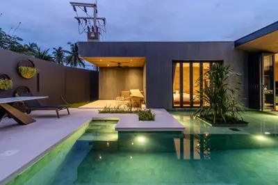 a swimming pool in front of a house at V253 Brand New 2BR with Pool and Full Kitchen in Thalang