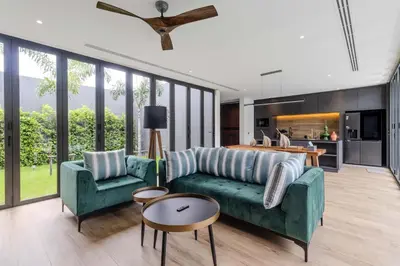 a living room with a green couch and two chairs at V253 Brand New 2BR with Pool and Full Kitchen in Thalang