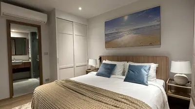 a bedroom with a large bed and a bathroom at 3bdr new apartmet in Laguna 50m form beasch LBS-3504 in Bang Tao Beach