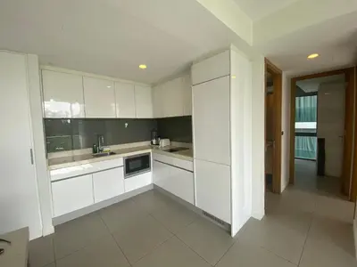 a white kitchen with white cabinets and appliances at 2bdr Apartment in Laguna Bangtao OCS-306 in Bang Tao Beach