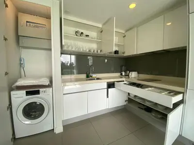 a white kitchen with a washer and dryer in it at 2bdr Apartment in Laguna Bangtao OCS-306 in Bang Tao Beach