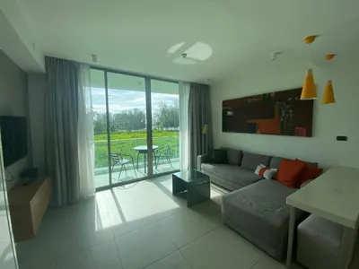 a living room with a couch and a large window at 2bdr Apartment in Laguna Bangtao OCS-306 in Bang Tao Beach