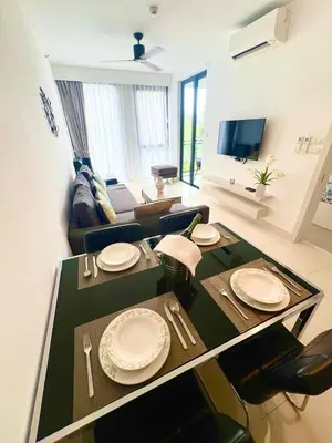 a living room with a table with plates on it at 1-bedroom apartment, Cassia Phuket in Laguna Phuket