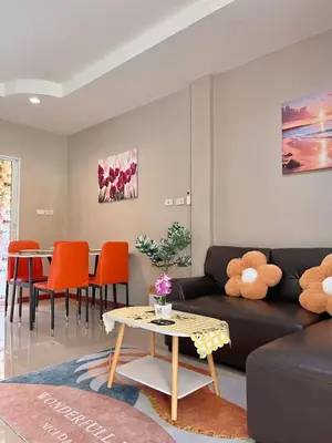 a living room with a couch and a table at Pluemjai mansion in Kathu