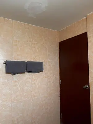 a bathroom with two glasses on the wall at Pluemjai mansion in Kathu