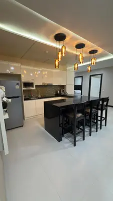 a kitchen with a black table and black chairs at Квартира в центре Бангтао в комплексе The Regent Bangtao in Bang Tao Beach