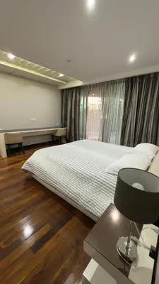 a bedroom with a large bed and a window at Квартира в центре Бангтао в комплексе The Regent Bangtao in Bang Tao Beach