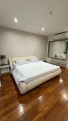 a bedroom with a large bed and a large mirror at Квартира в центре Бангтао в комплексе The Regent Bangtao in Bang Tao Beach