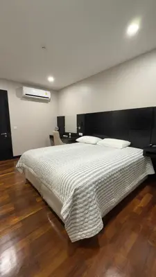 a bedroom with a large bed with a white comforter at Квартира в центре Бангтао в комплексе The Regent Bangtao in Bang Tao Beach