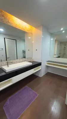 a bathroom with a large mirror and a purple rug at Квартира в центре Бангтао в комплексе The Regent Bangtao in Bang Tao Beach