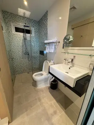 a bathroom with a sink and a toilet at Beachside Bliss in Ban Saiyuan (1)