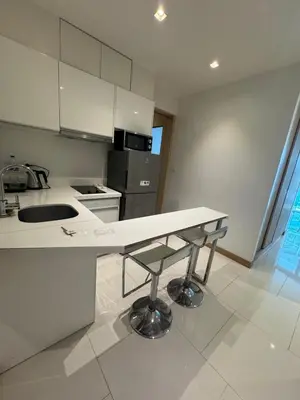 a white kitchen with a sink and a counter at Beachside Bliss in Ban Saiyuan (1)