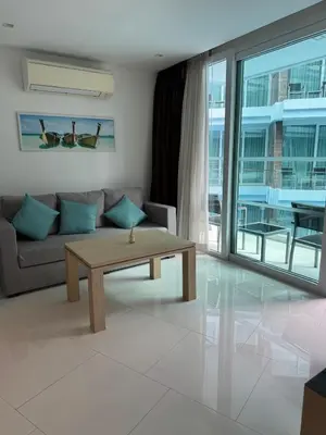 a living room with a couch and a coffee table at Beachside Bliss in Ban Saiyuan (1)