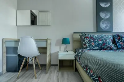 a bedroom with a bed and a chair and a mirror at Cozy apartment by the sea F410 in Nai Yang Beach