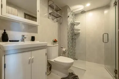 a bathroom with a toilet and a sink and a shower at Cozy apartment by the sea F410 in Nai Yang Beach