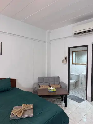 a living room with a bed and a couch at Hana apartment in Patong Beach